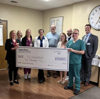 Santa Rosa Medical Center Donation. Randi Cromer, FSU Development Officer   Cindy Drummond, FSU Community Board Member   Genevieve Hinks, DO  Emily Fletcher, MD  Melissa Mekesa, MD  Badr Sultan, MD     Back row:  Reese Benoit, MD  Tucker Retherford, MD  Mike Nordness, CEO