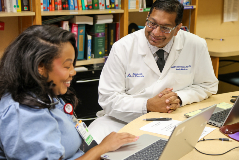 A medical student studying with a mentor