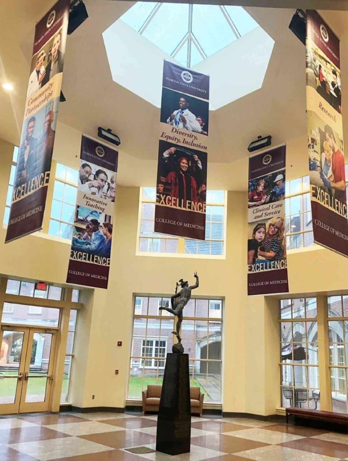The College of Medicine's five pillars of excellence hang in the atrium.