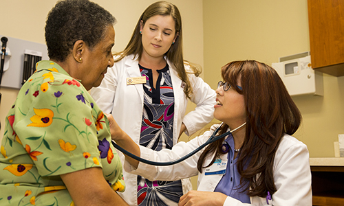 Alumna and student w patient - Copy1