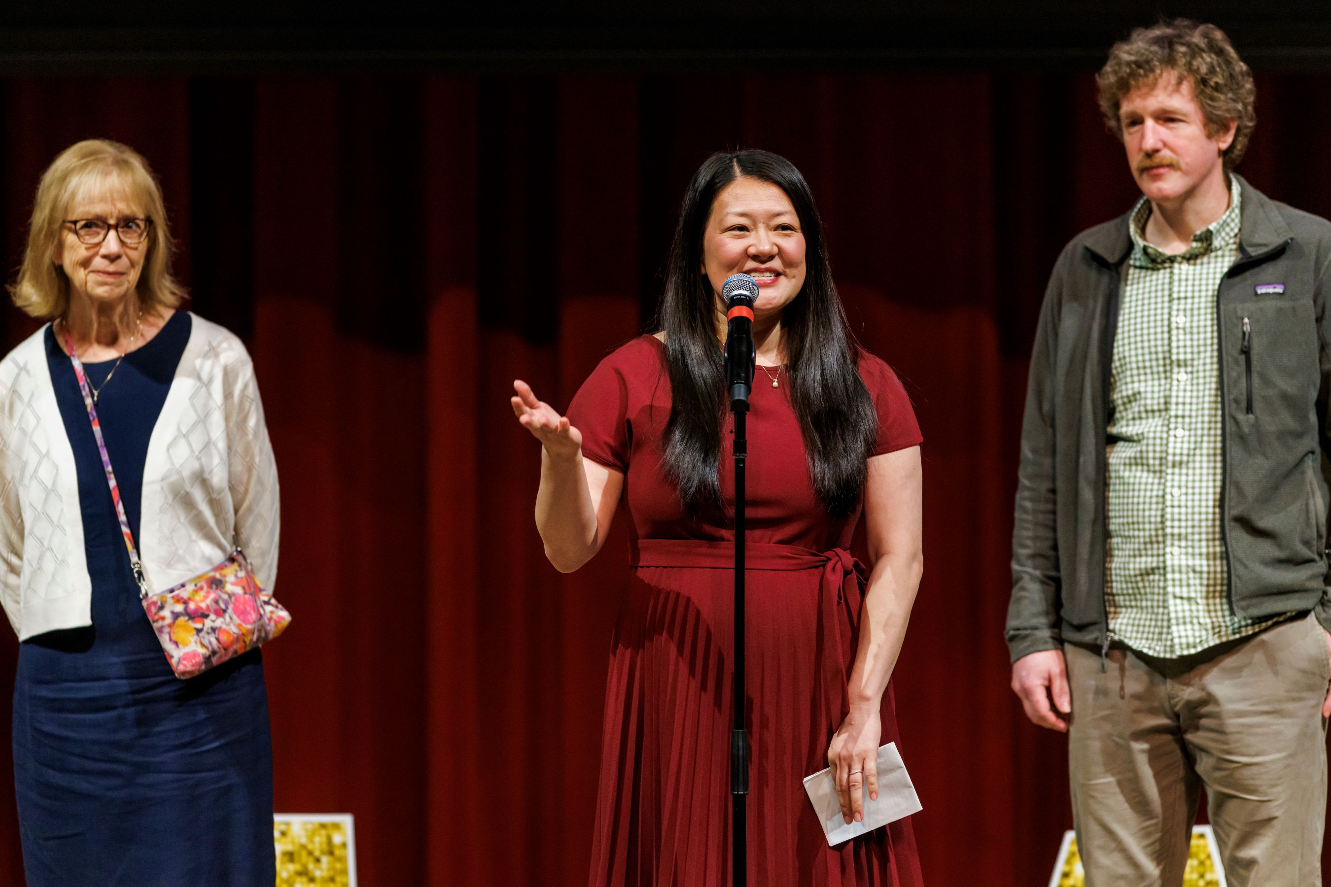 M.D. Class of 2026 President Alycia "Aly" Savage, center, announces her match. With her are her mother and her husband.