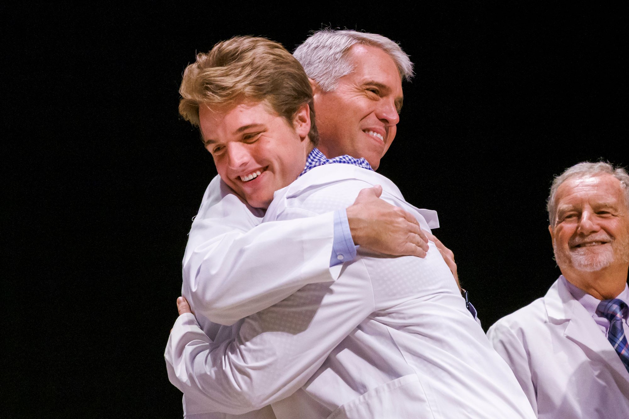 Dr. Hugh VanLandingham hugs his son Hal.