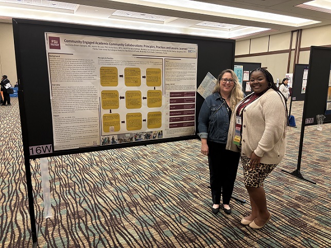 Ericka Horne and Katheryn Baughman with poster