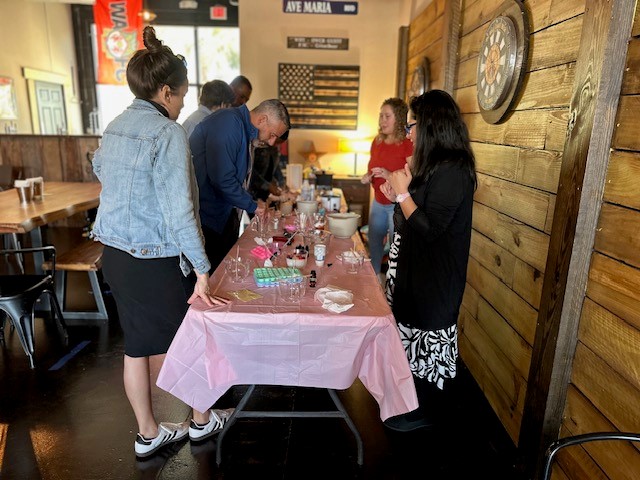 Attendees of the workshop around the candlemaking table.