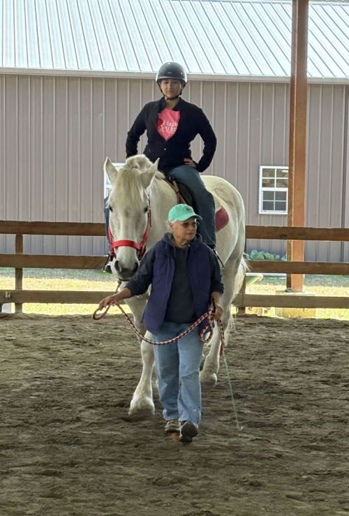 Student, Khadeja Ahmed, riding a horse.