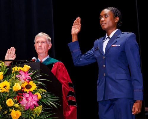 Dean Emeritus John P. Fogarty leads U.S. Air Force Capt. Keri G. Wortherly as she reaffirms her oath of office after promotion.