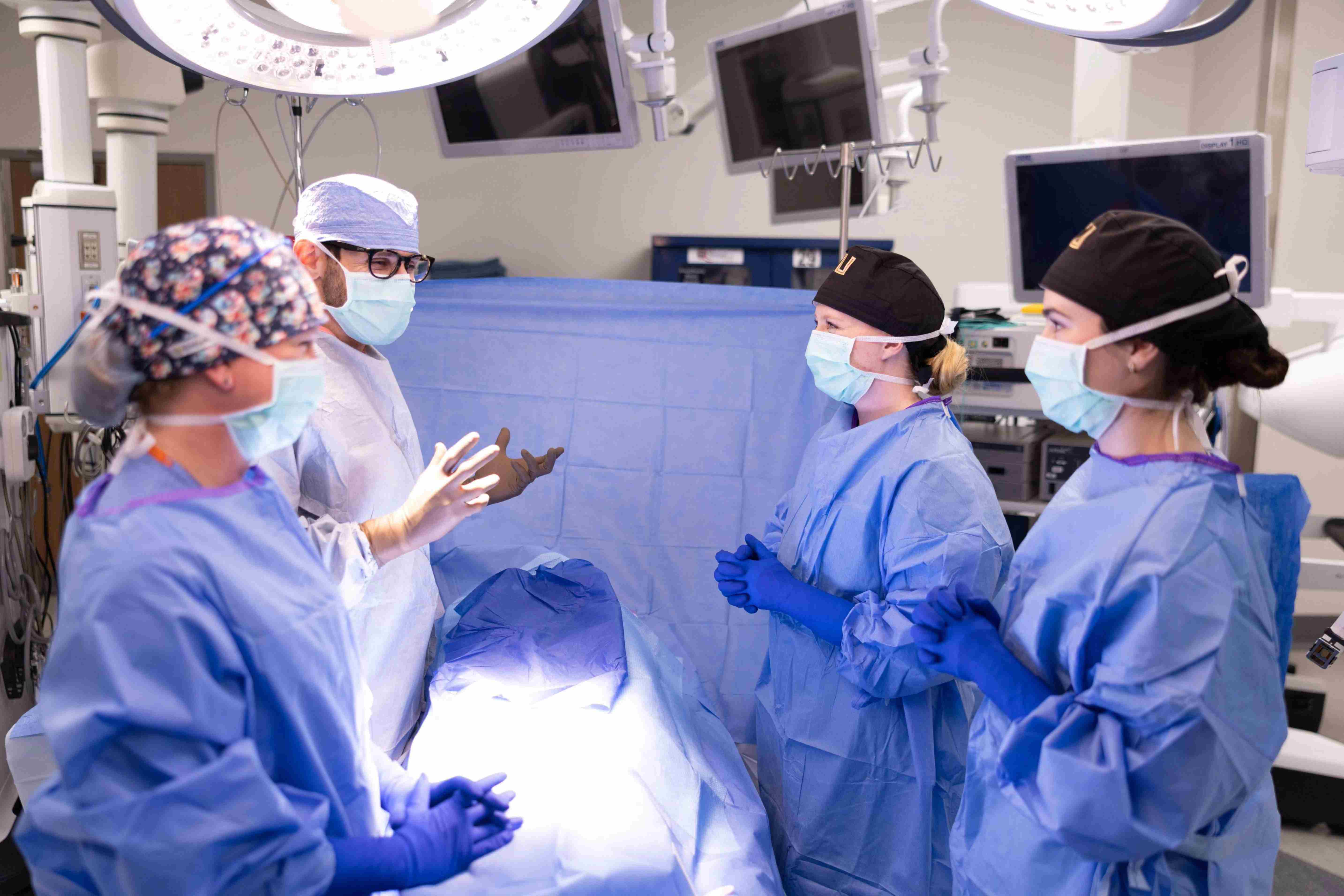 Fellows in surgery scrubs have a discussion