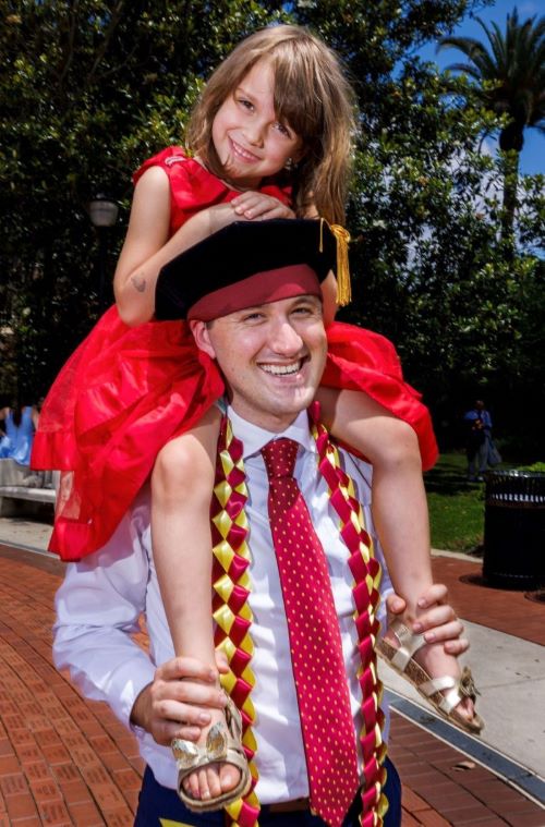 Dr. Tim Gemesi carries his niece Mia Gemesi on his shoulders.