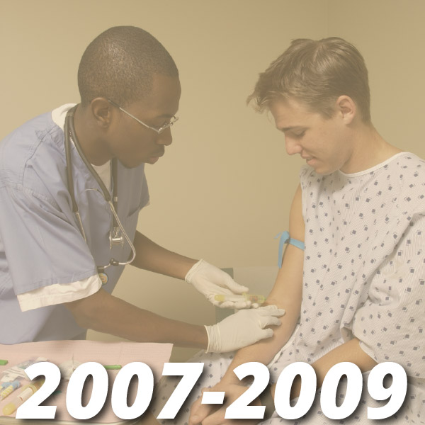 2007-2009. Student in scrubs draws blood from another student