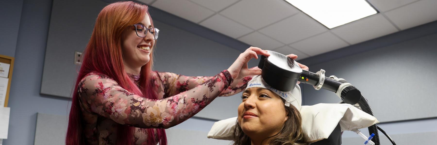 image of staff administering TMS to a fake participant