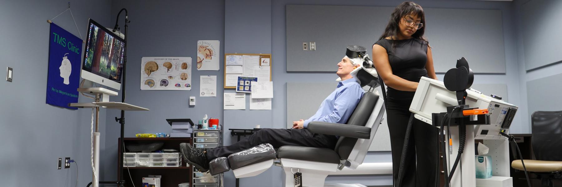 image of staff preparing the TMS machine for research