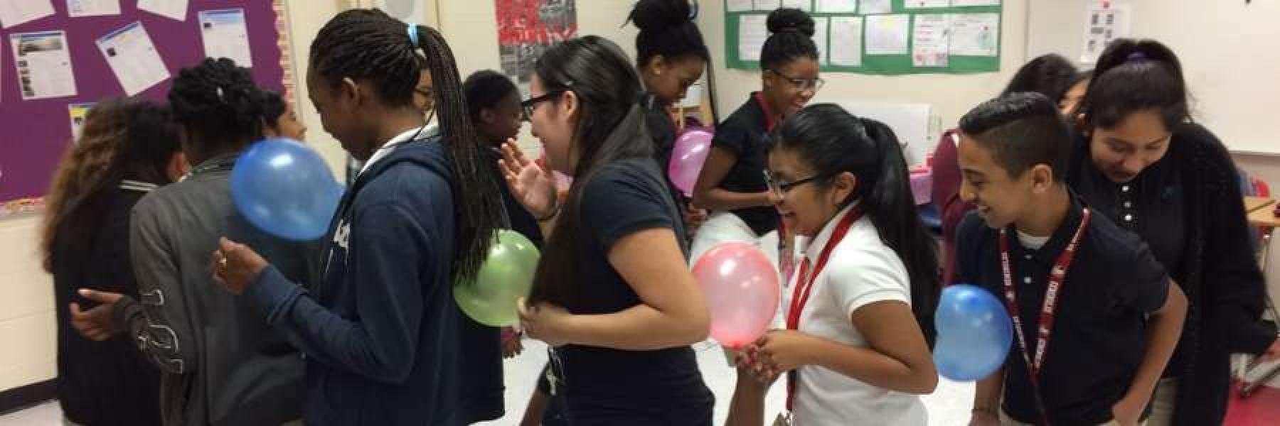Students doing a balloon line up circle activity