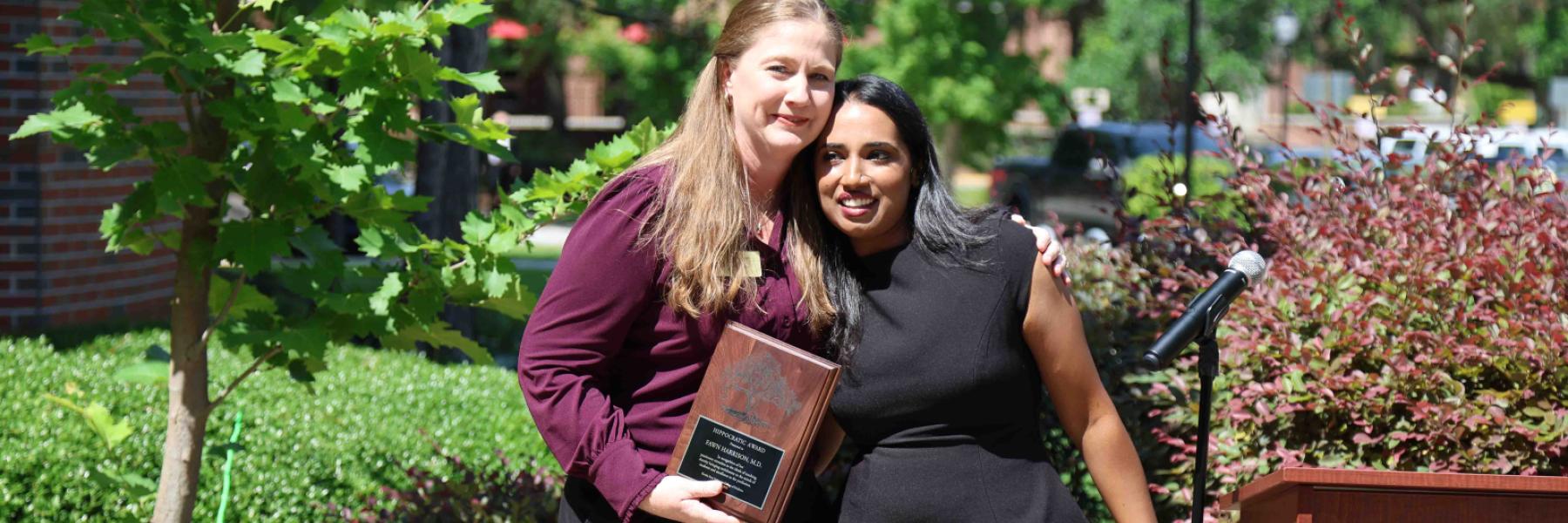 Dr. Fawn Harrison, left, was presented the 2026 Hippocratic Award by Sarasota Regional Campus student, Nicole Uthuppan.
