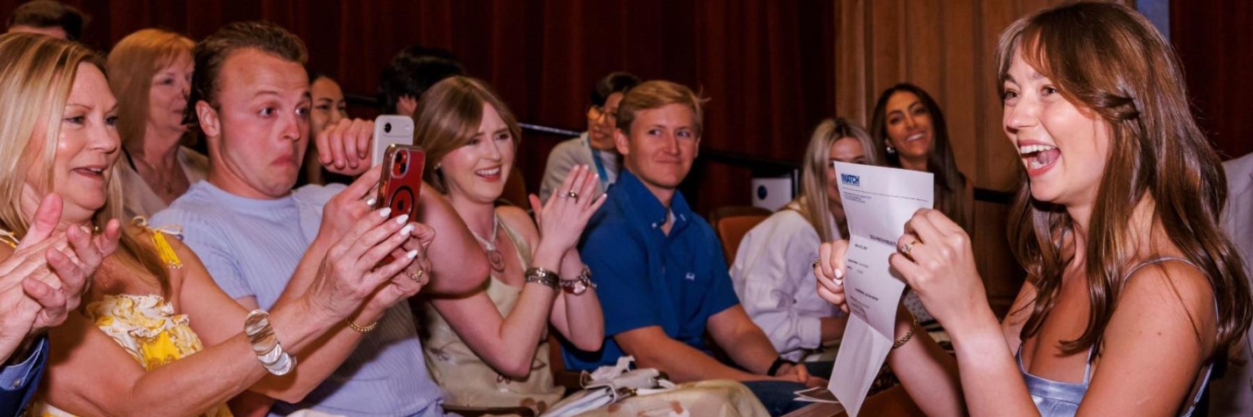 Sarah Whitteker shows her match letter to her family in Ruby Diamond Concert Hall.