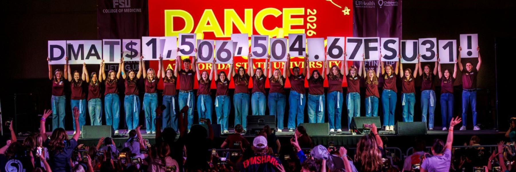 Dance Marathon leaders hold up placards revealing the 2026 total raised was $1,506,504.67.