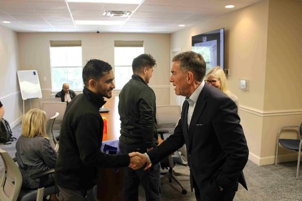 A resident shakes hands with Dr. Jay Reeve