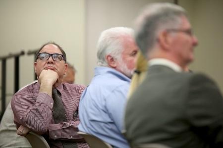 Dr. John Agens taking interest in a student presentation.