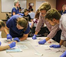 Class of 2023 students Alan Riley, Benjamin Borgert, and Tim Carter learn dermatology procedure techniques. 