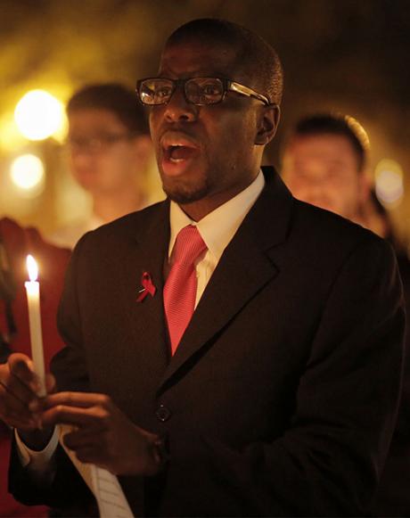 Eric Walker, with others, holding candles