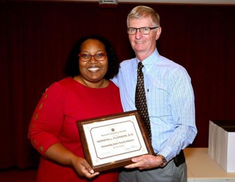 Dean Fogarty presents Dr. Flowers with the Outstanding Junior Faculty Award.