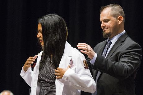 Nair-Collins coating his wife, Sangeeta Nair-Collins.