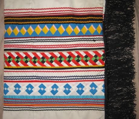 Brightly colored Seminole patchwork fringed dance shawl