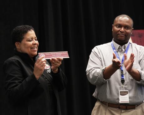 Thesla Anderson displays her new nameplate with Ed.D. on it presented by Dr. Anthony Speights.