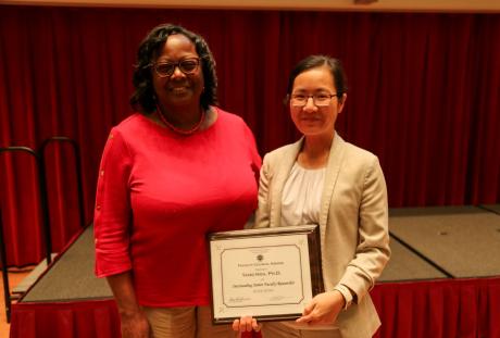 Dean Alma Littles, M.D., poses with Assistant Professor Yang Hou after the was named the College of Medicine's Outstanding Junior Researcher