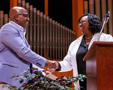 Interim Dean Alma Littles thanks Folusho Ogunfiditimi for being keynote speakers at the PA Class of 2025 White Coat Ceremony