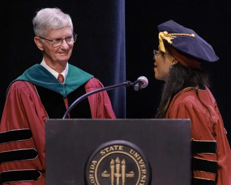 Class President Stenia Accilien thanks retiring Dean John Fogarty, M.D.