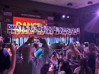 Crowd shot of Dance Marathon 2026 dancers looking at stage, where reveal shows more than $1.5 million was raised this year. 