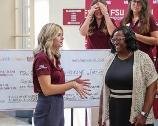 Grace Massari, executive director of Dance Marathon at FSU for the current academic year, talks with College of Medicine Dean Alma Littles, M.D., after the ceremony.