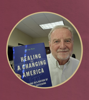 Photo of George Rust holding book