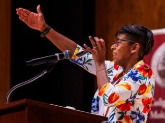 Rebecca Mangali leads the crowd in FSU's tomahawk chop.