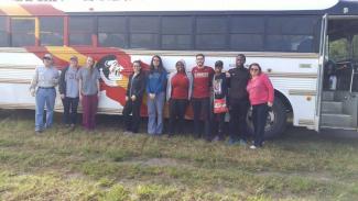 group picture in front of bus