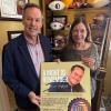 Chris and Kellie Kraft hold a poster with a photo of their son